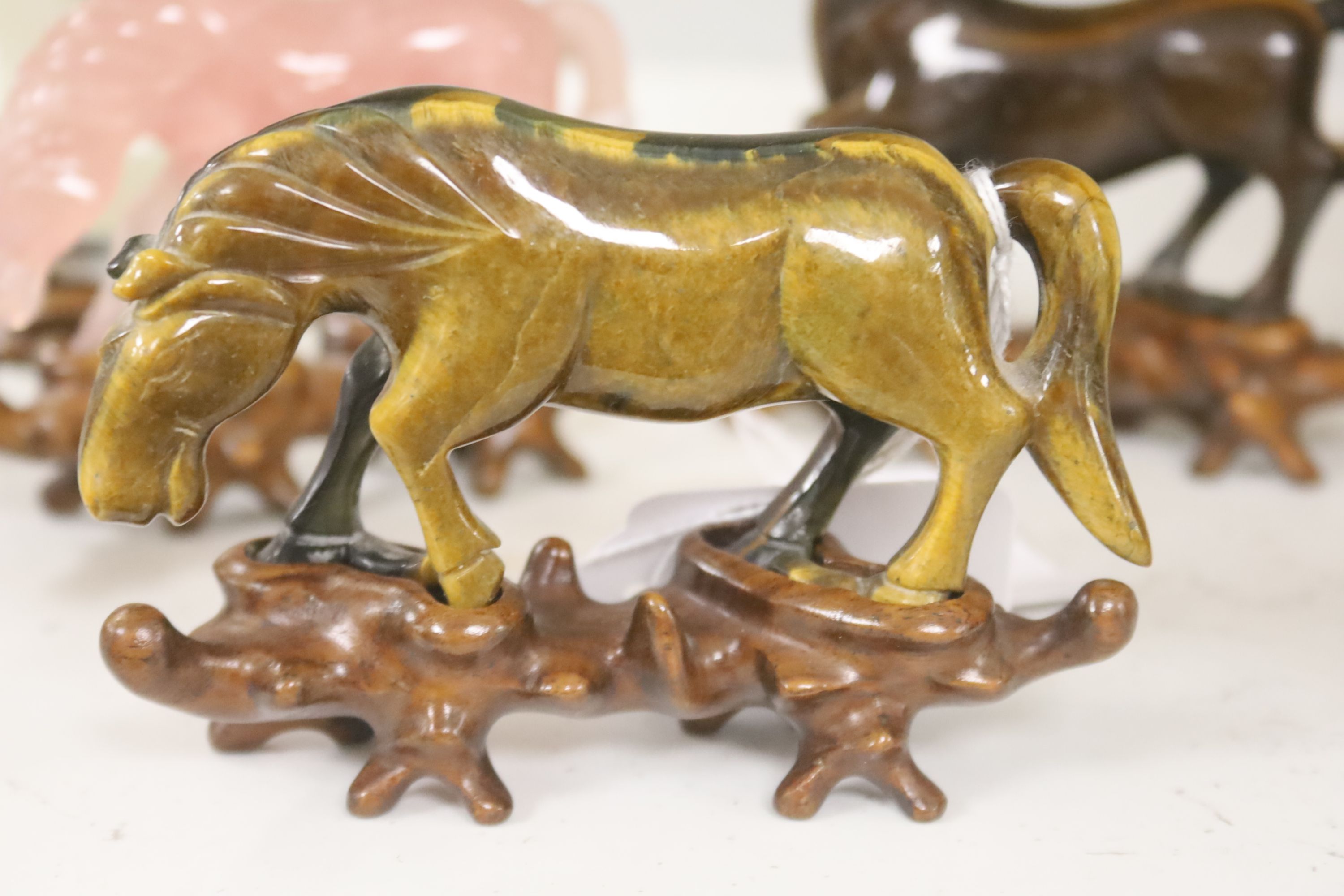 Eight Chinese 20th century carved hardstone 'Horses of Mu Wang'